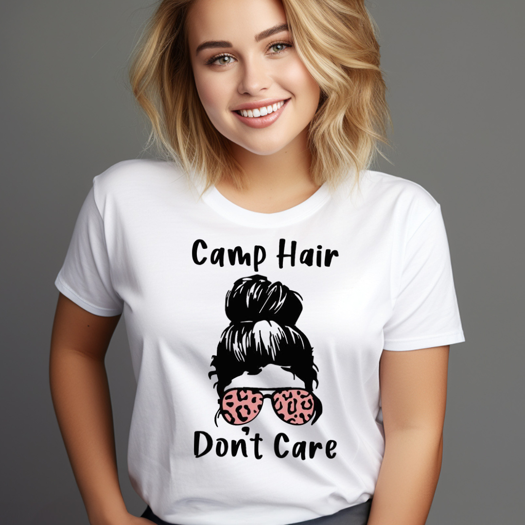 Woman wearing a white t-shirt with Camp Hair Don't Care graphic and leopard print sunglasses