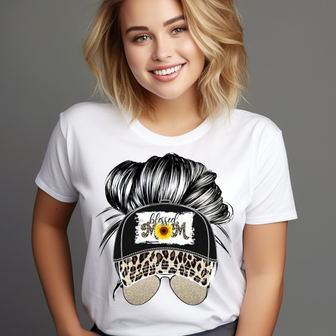 Woman wearing a white t-shirt featuring a graphic of a messy bun with a leopard print Messy Bun Hat for Women and sunglasses