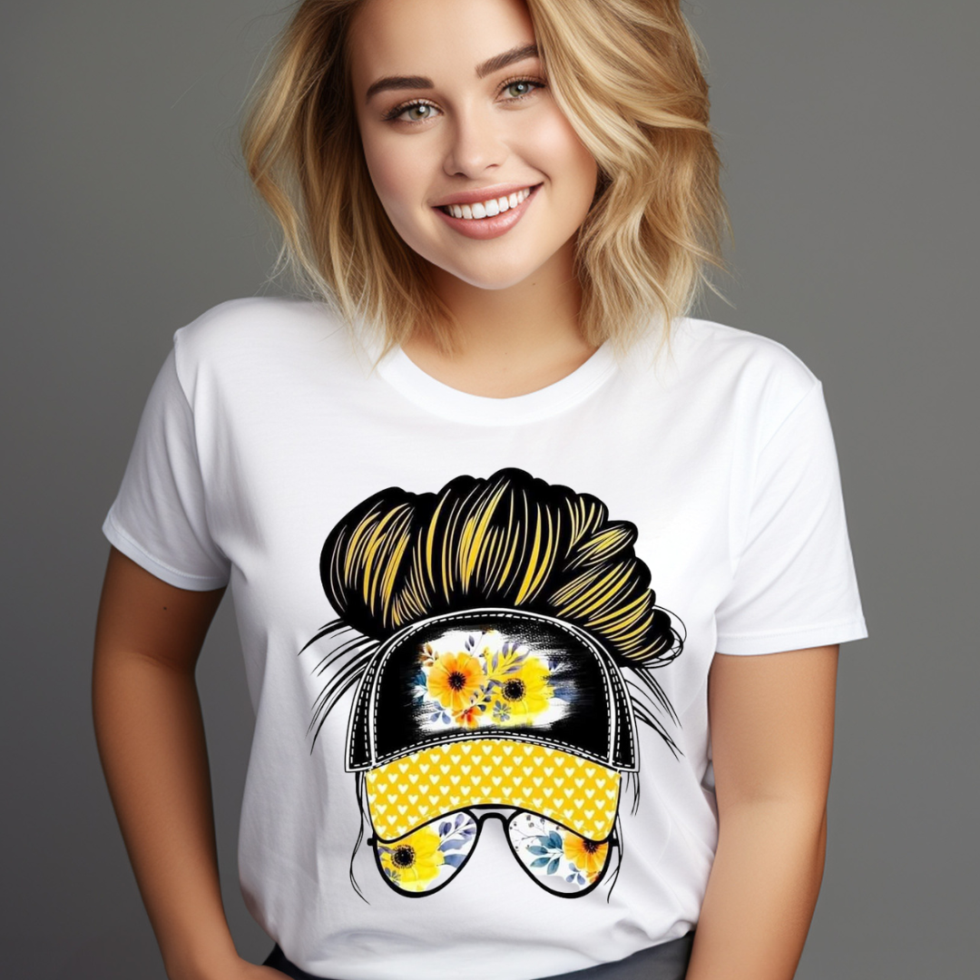 White t-shirt featuring a graphic of a messy bun sunflower hat with yellow flowers and sunglasses