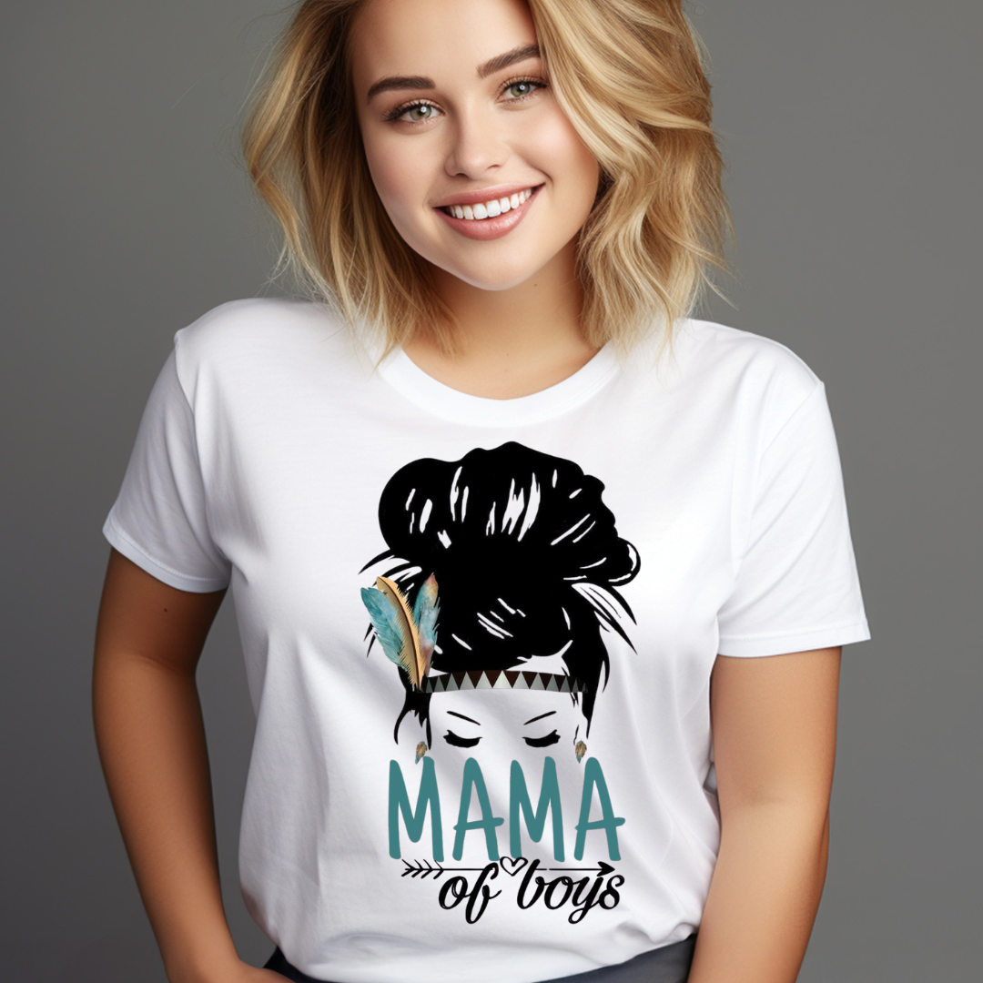 Smiling woman wearing a white Mama of boys shirt with a graphic of a woman with a feather in her hair