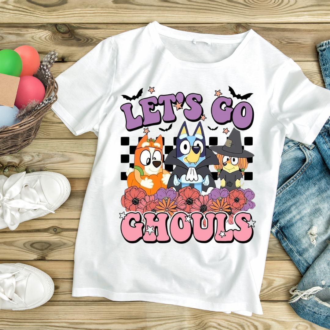 White t-shirt with colorful cartoon characters and text Let’s Go Ghouls featuring ghouls themed clothing design