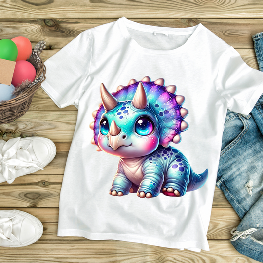 White t-shirt with colorful baby dino graphic featuring a cute triceratops with big eyes