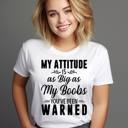 Woman wearing a white bold statement shirt with black text attitude as big as my boobs you've been warned