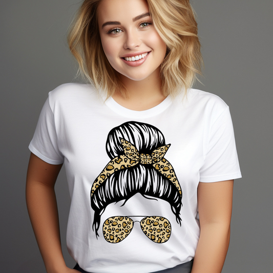 Smiling woman wearing a white casual bun graphic tee with leopard print sunglasses and matching hair bow