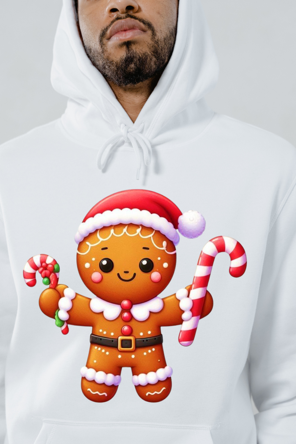 White hoodie featuring a cute gingerbread design clothes graphic of a smiling gingerbread man with candy canes