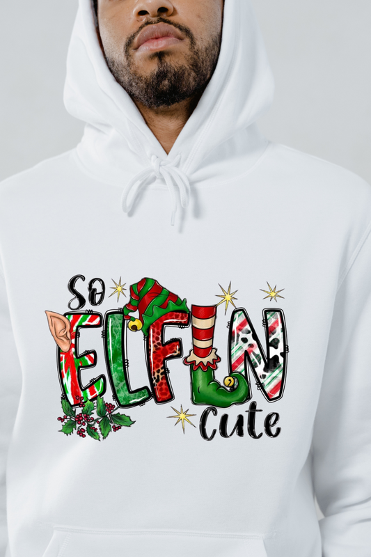 White festive elf hoodie with colorful elf-themed text design and holiday decorations