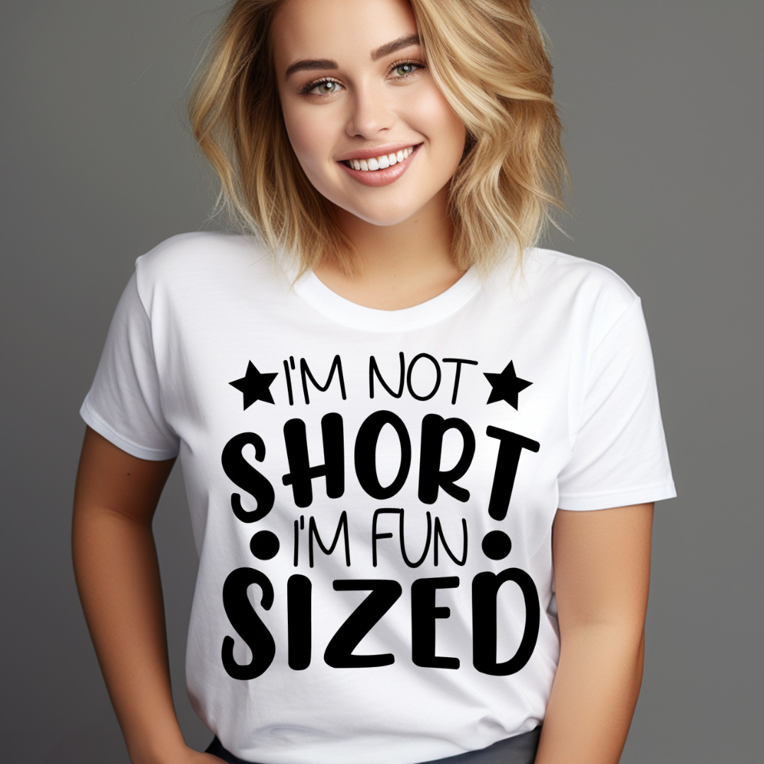 White funny short t-shirt with black text saying I’m not short I’m fun sized worn by smiling woman