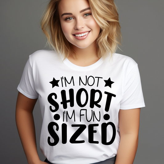 White funny short t-shirt with black text saying I’m not short I’m fun sized worn by smiling woman
