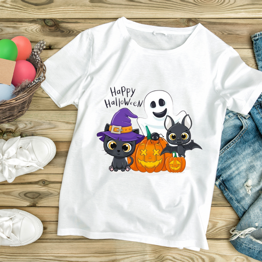 White happy Halloween graphic tee with cartoon ghost, witch cat, bat, and pumpkins on wooden background