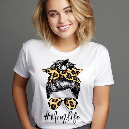 Woman wearing a white leopard print mom t-shirt with a stylish hair bun and sunglasses design