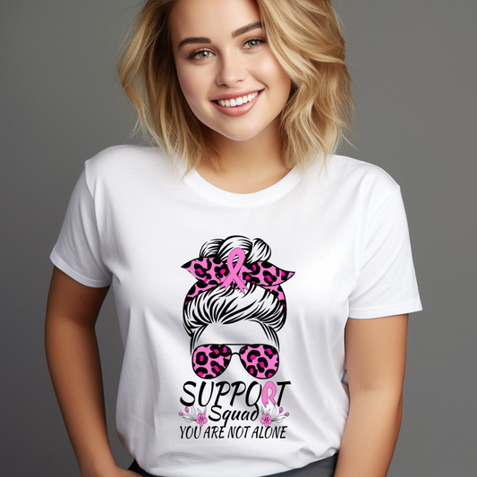 Smiling woman wearing a white t-shirt with messy bun cancer awareness design featuring pink leopard print and support squad text