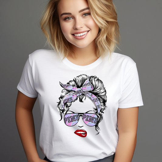 Woman wearing a white Messy Bun Pink T-Shirt with graphic of hair in a messy bun and pink sunglasses