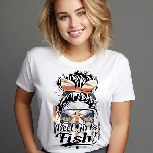 Woman wearing a white reel girls fish t-shirt with fishing-themed graphic and sunglasses