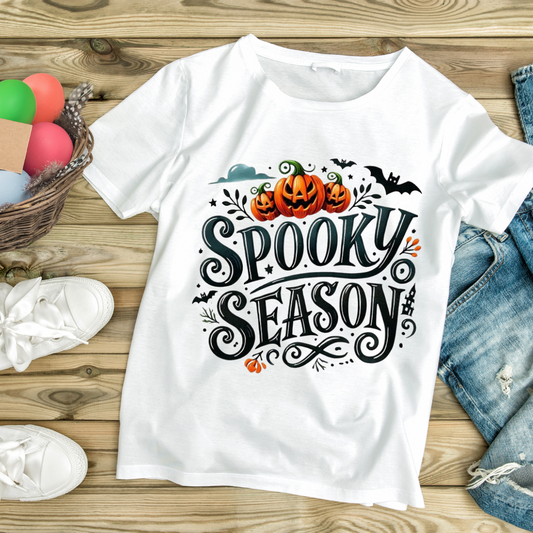 White Halloween graphic tees with spooky season design featuring pumpkins and bats