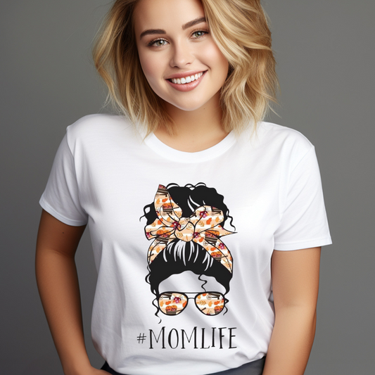 Smiling woman wearing a customizable creations messy bun mom life t-shirt with graphic and hashtag momlife