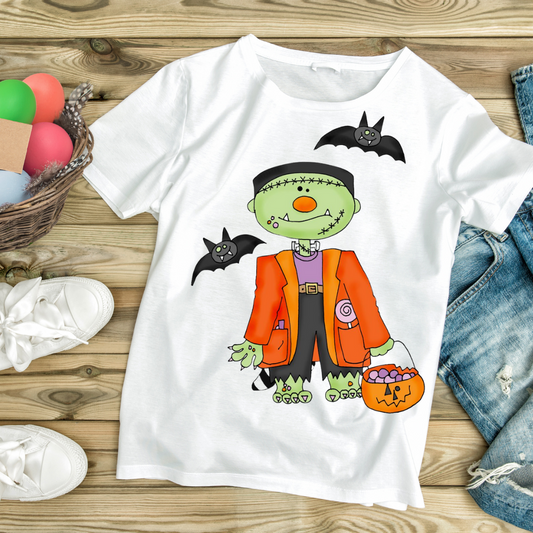 White trick or treat monster tee featuring a cartoon Frankenstein with bats and pumpkin candy bucket