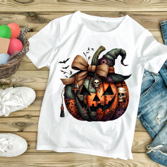 White t-shirt with detailed Halloween pumpkin design featuring bats, skulls, and a witch hat