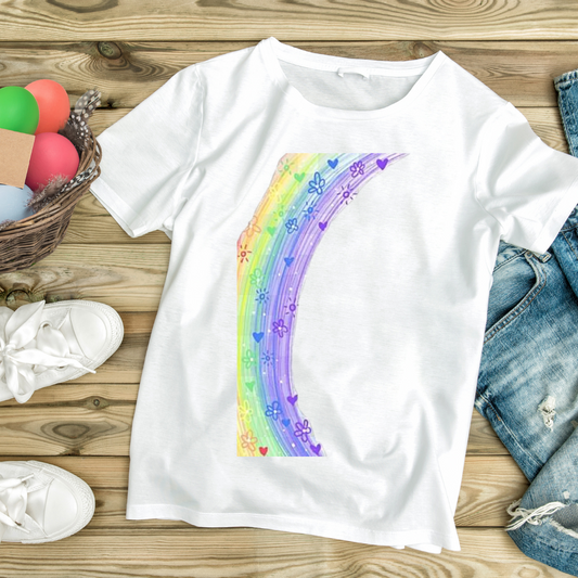 White t-shirt with colorful rainbow and flower design laid flat with denim jeans and white sneakers