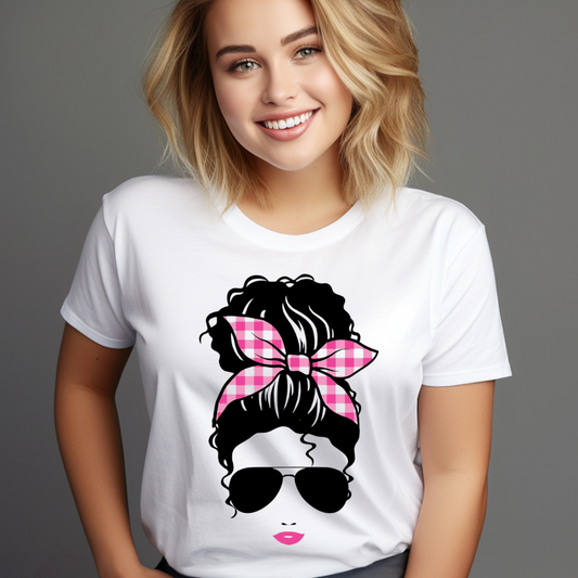 Woman wearing a white t-shirt with a graphic of a woman with a pink checkered headband and sunglasses